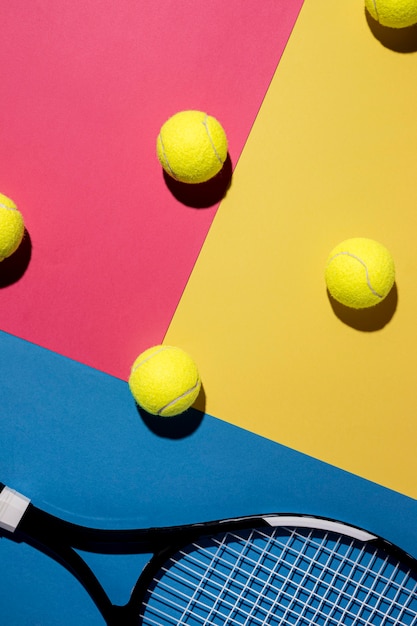 Flat lay of tennis balls with racket