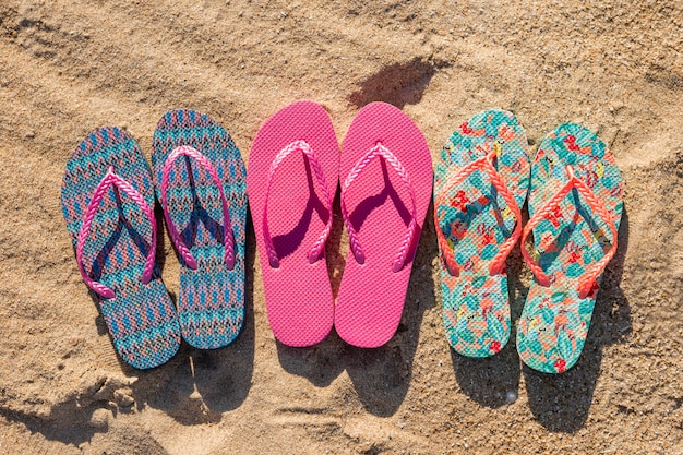 Flat lay of three pairs of flip flops