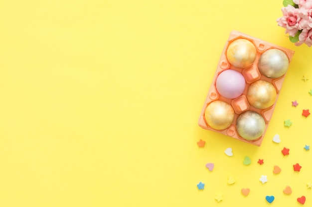 Free Photo flat lay top view colorful easter egg painted in pastel colors composition and spring flowers 