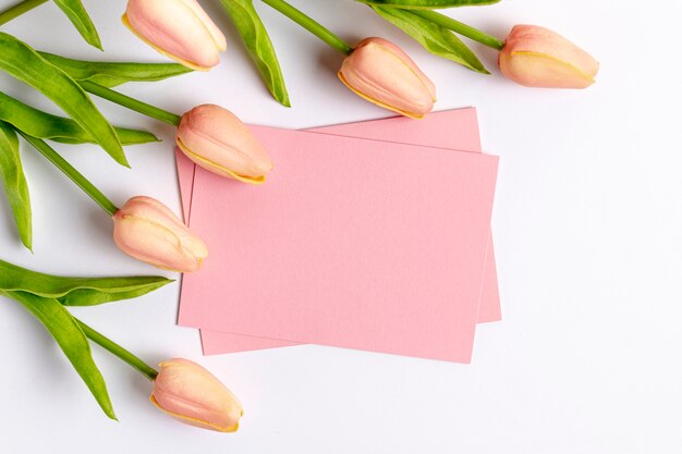 Flat lay of tulips and paper with copy space for valentines day