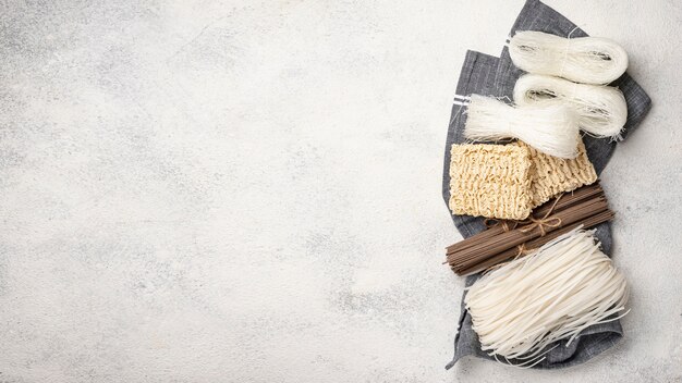 Flat lay uncooked assortment of noodles with copy space