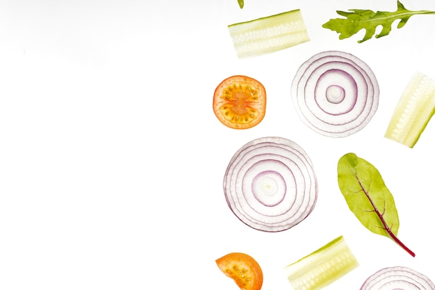 Free photo flat lay vegetables slices with copy space