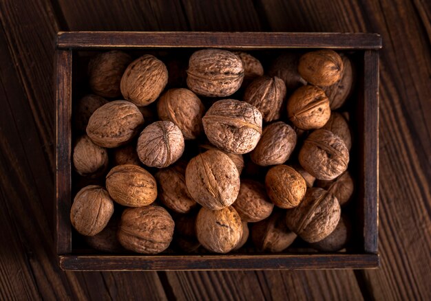 Flat lay walnuts in wooden box