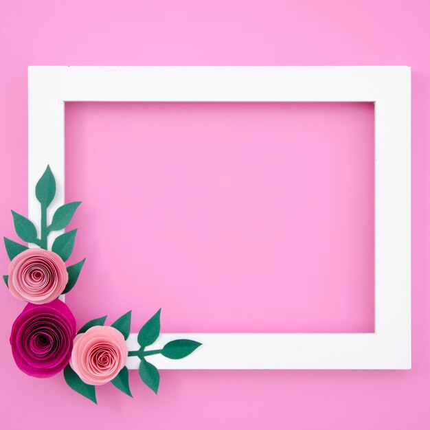 Flat lay white floral frame on pink background