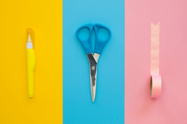 Free Photo flat lay of white-out pen with tape and scissors