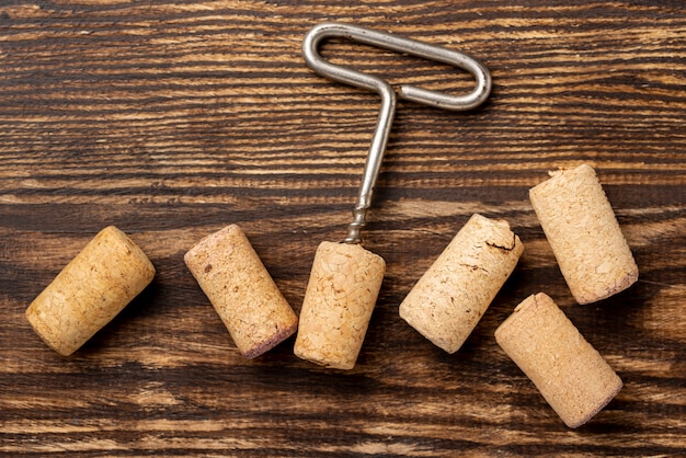 Flat lay wine stopper collection beside corkscrew