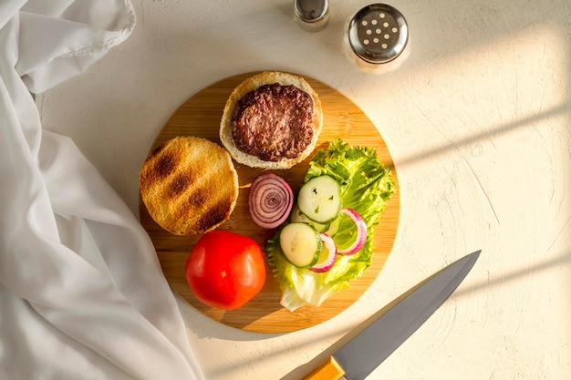 Flat lay wooden board with hamburger