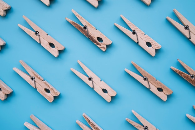 Free Photo flat lay wooden clothespins on blue background