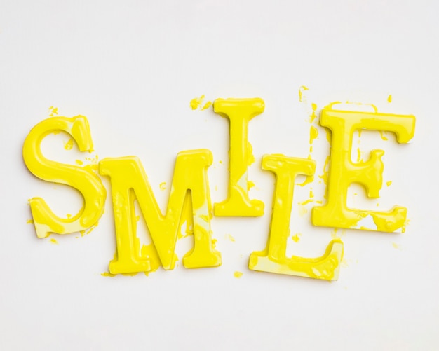 Free photo flat lay of word smile with paint