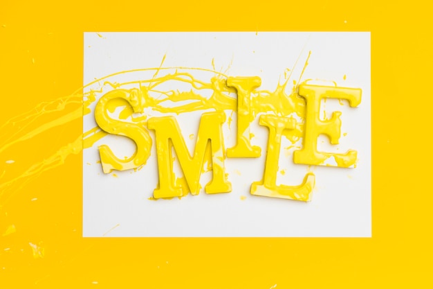 Free photo flat lay of word smile with paint