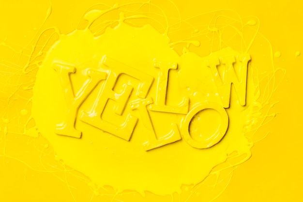 Free Photo flat lay of word yellow with paint