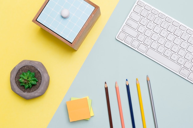 Free photo flat lay of workspace with keyboard and pencils