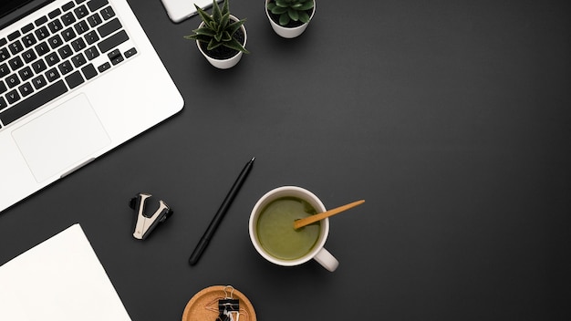 Free Photo flat lay of workstation with cup of tea and copy space