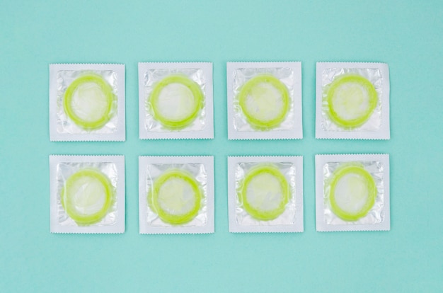 Free Photo flat lay wrapped green condoms