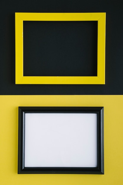 Free photo flat lay yellow and black empty frames