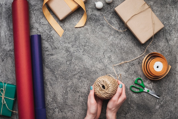 Free photo flay lay of hands packing christmas gifts