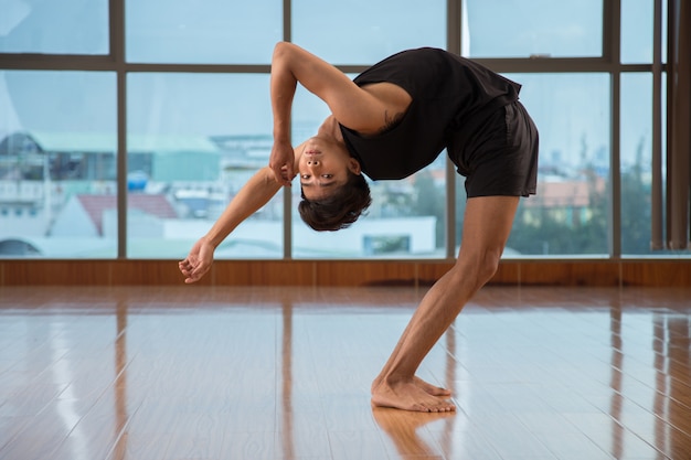 Flexible guy dancing in studio