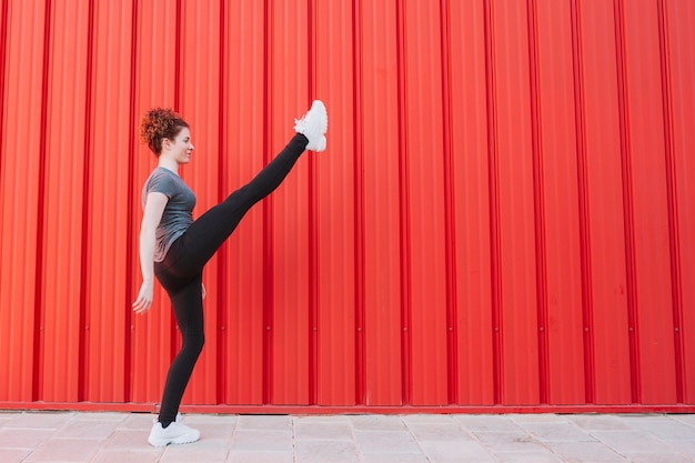 Free photo flexible sportswoman training on street