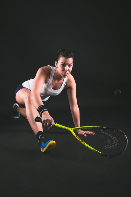 Flexible young player hitting the ball