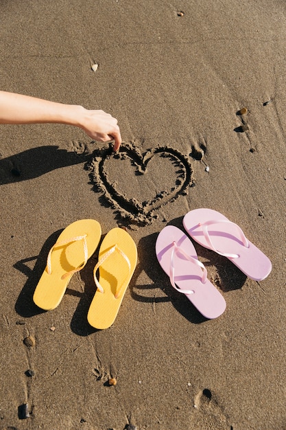 Free photo flip flops in the sand at the beach