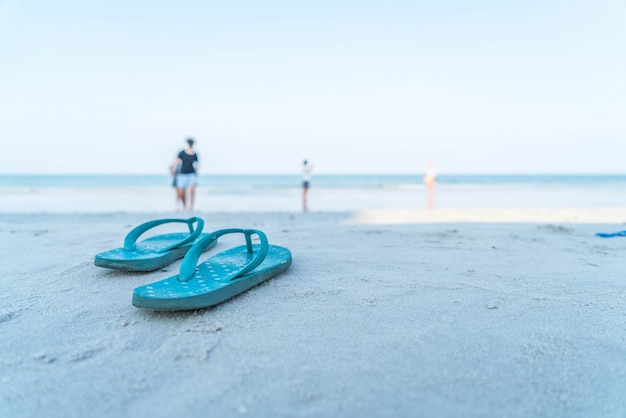 Flipflops on a sandy ocean beach