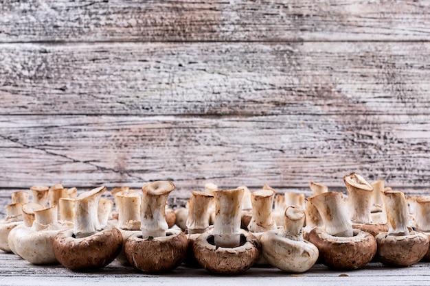 Free Photo flipped mushrooms on a wooden table. side view.