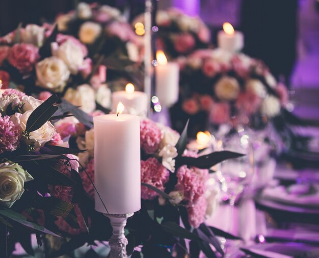 Floral centerpieces with flaming candles