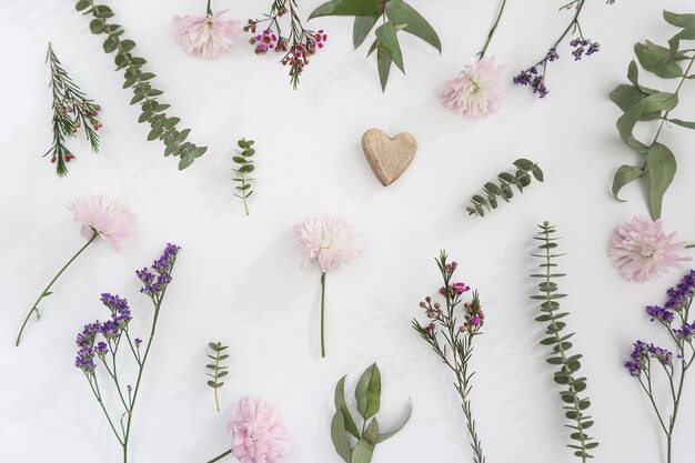 Floral decoration with heart on white background