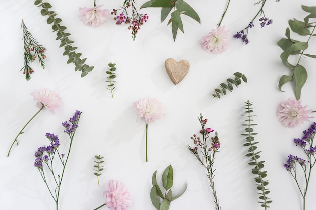 Floral decoration with heart on white background