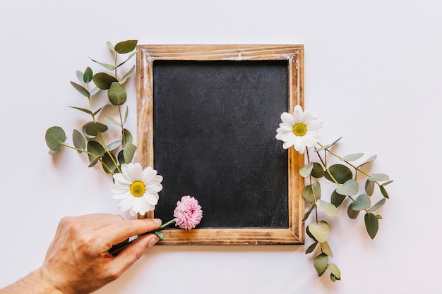 Floral slate composition with hand