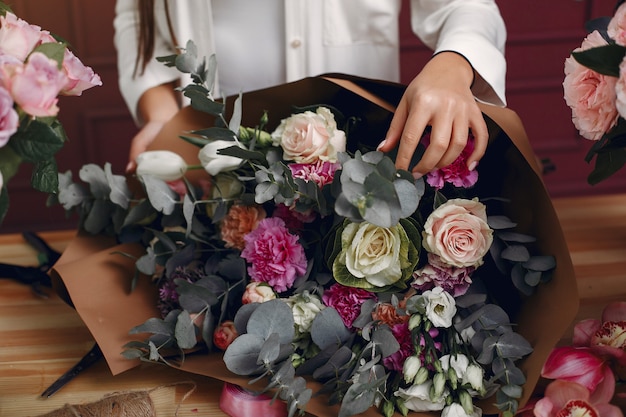 Florist makes a beautiful bouquet in a studio