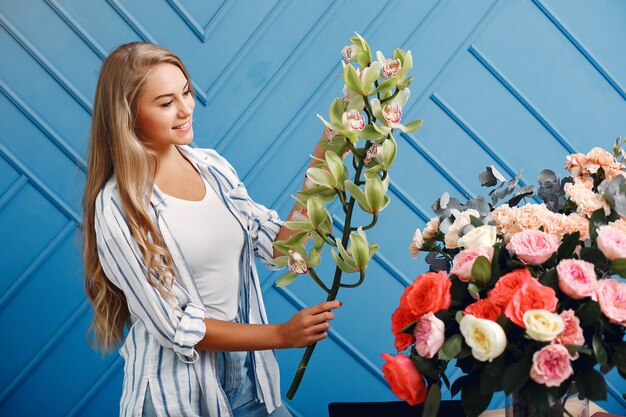 Florist makes a beautiful bouquet in a studio