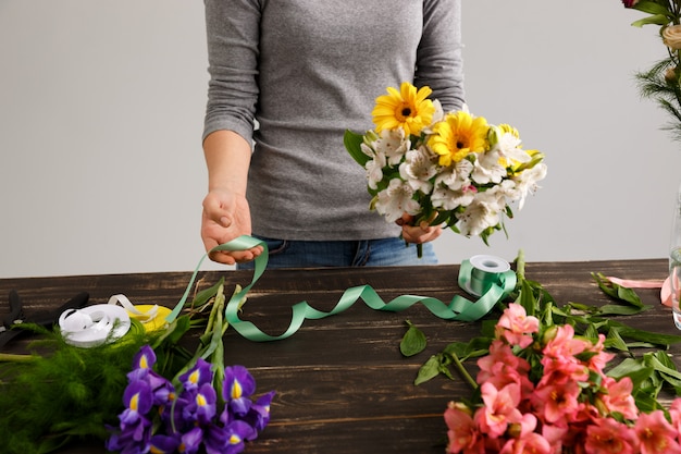 Free Photo florist woman make bouquet from colorful flowers