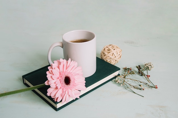 Free Photo flower and beverage on notebook