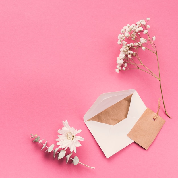 Flower branches with envelope on table