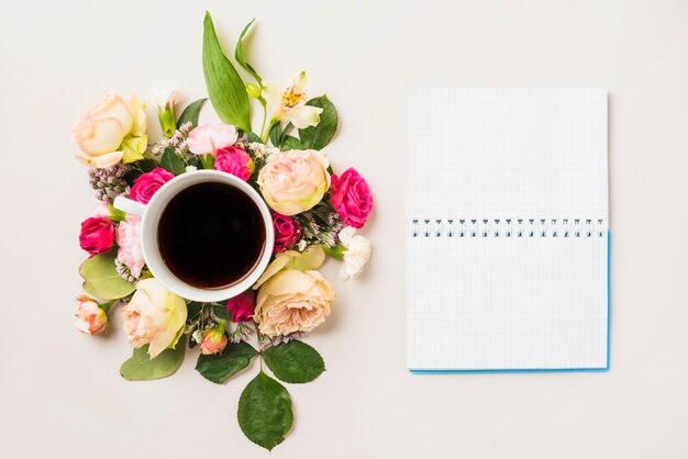 Flower composition and beverage near notebook