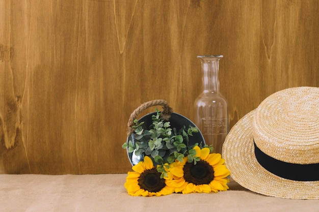 Flower composition with bucket and hat