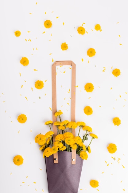 Free photo flower heads near bag with bouquet