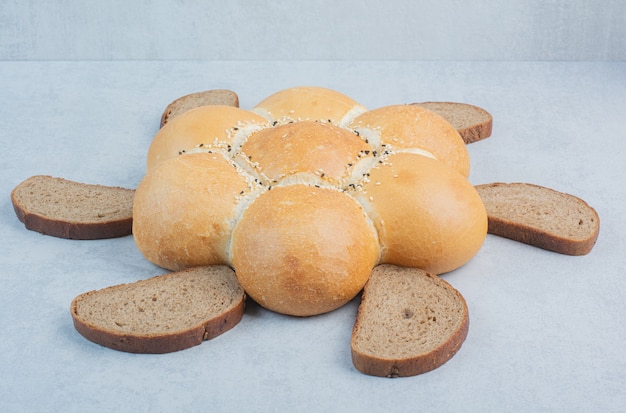 Flower shaped bread and bread slices on white background. High quality photo