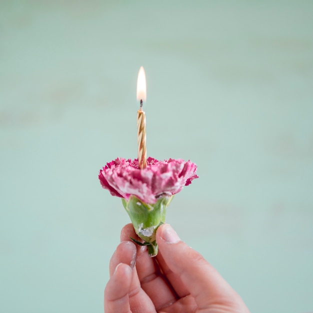 Free photo flower with lit candle