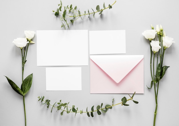 Flowers beside wedding invitation on table