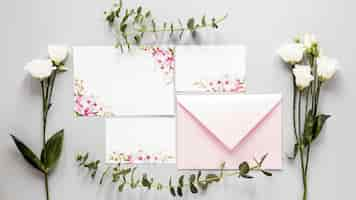 Free photo flowers beside wedding invitation