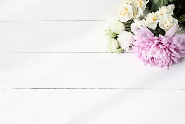 Flowers bouquet on wooden background