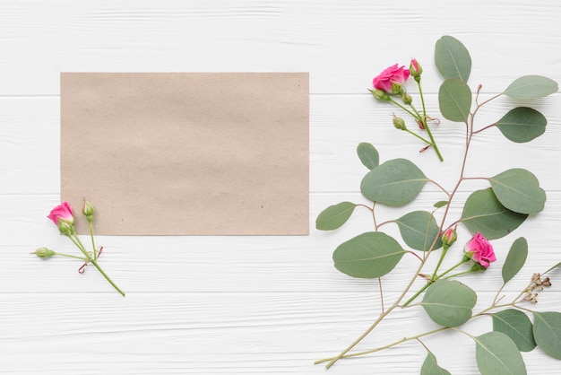 Flowers and branches near paper sheet