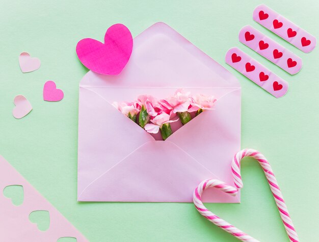 Flowers in envelope with paper hearts 