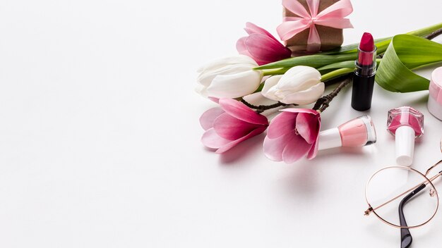 Flowers and feminine objects on white background