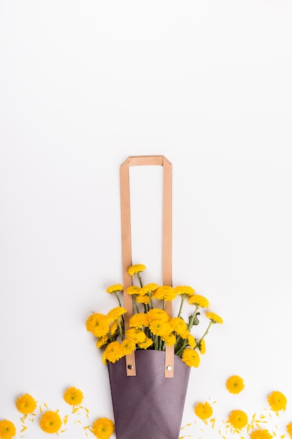 Free photo flowers near bag with bouquet