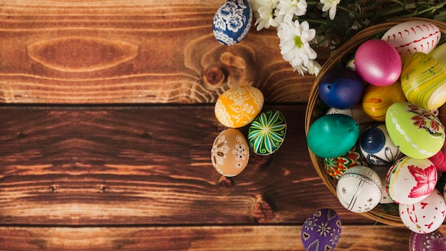 Free photo flowers near basket of eggs