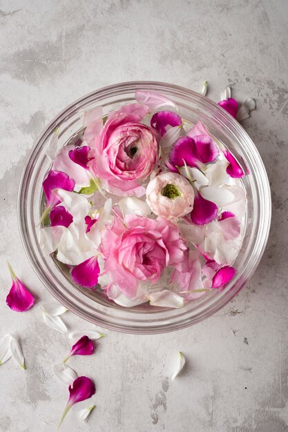 Flowers petals in bowl on table