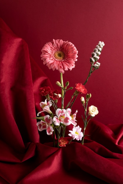 Flowers in vase with red background